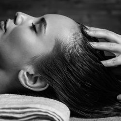 Masseur doing massage the head and hair for an woman in spa salon